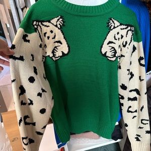 Green and white jaguar sweater, new without tags. Size medium. Tagless.
